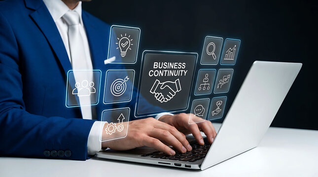 Businessman typing on laptop with business continuity digital interface