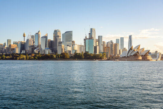 Sydney, Australia - May 01, 2026: Central Business District skyline and Opera House under clear sky at sunset in autumn.