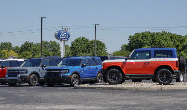 Ford Bronco and Bronco Sport display at a dealership. Bronco is a heavy off-roader and Bronco Sport is for light trail use.