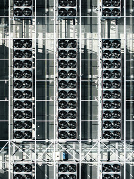 Aerial view of the EU North Riga LV DC1 data center rooftop featuring rows of industrial cooling fans for high-performance computing infrastructure in Riga, Latvia.