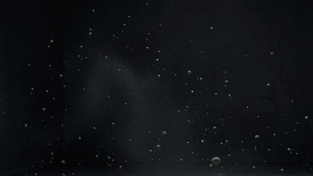 Floating dust drifting through a dark empty room, creating a quiet sense of solitude with soft cinematic light and atmospheric motion, created with Generative AI.