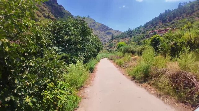 Small winding roads weave through Najigram Dara&rsquo;s greenery, flanked by towering mountains on both sides.&rdquo;