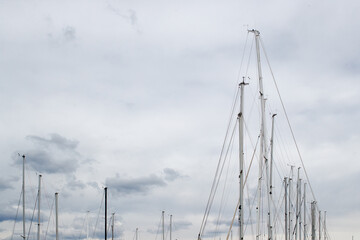 Sailboat masts against a cloudy sky © 2xwilfinger