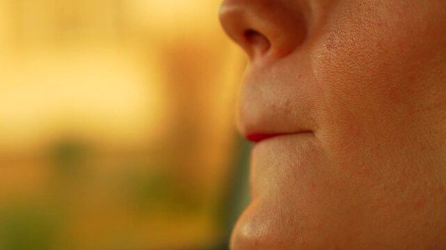Lipstick woman makeup application of red gloss on lips outdoors during golden hour for an elegant evening look