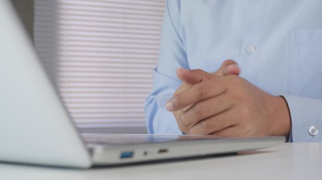 Business professional pausing laptop and tablet work to massage tired hand muscles, highlighting hand fatigue relief, workplace wellness, ergonomic habits, productivity care, office health awareness