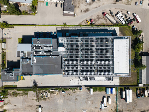 Aerial view of the EU North Riga LV DC1 data center featuring rows of cooling units on the roof and a surrounding industrial site in Riga, Latvia.