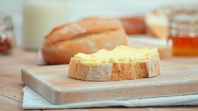 Butter spreading on fresh bread slice, close up homemade breakfast scene, copy space