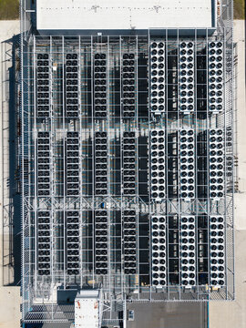 Aerial view of the EU North Riga LV DC1 data center roof featuring rows of industrial cooling fans and HVAC infrastructure in Riga, Latvia.