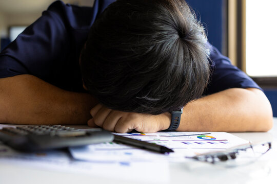 Exhausted office worker with low battery concept showing burnout, fatigue and work overload