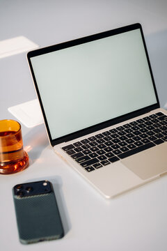 A laptop with a white screen on a desk