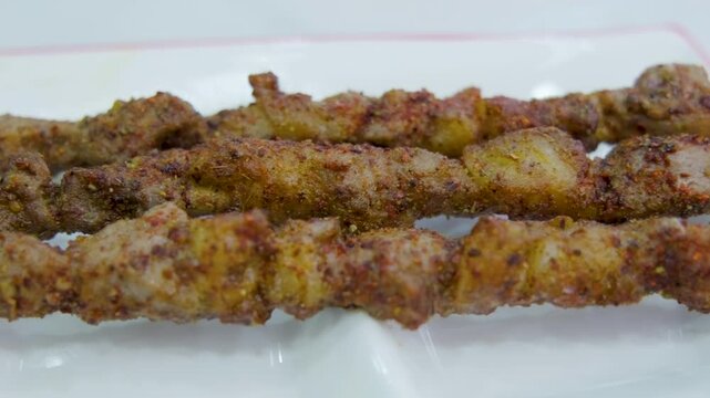Delicious Grilled Mutton Skewers With Spiced Seasoning On White Ceramic Plate