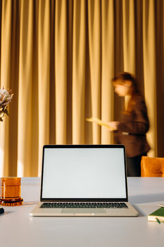 A laptop with a white screen on a desk