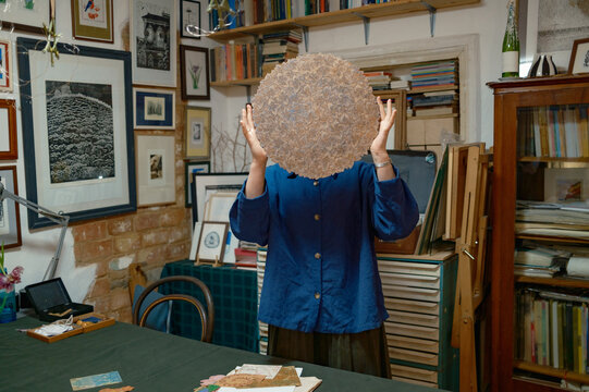 a female artist lays out her works on a table