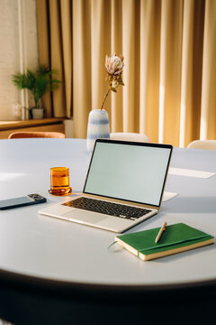A laptop with a white screen on a desk