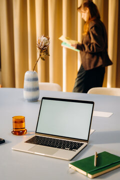 A laptop with a white screen on a desk