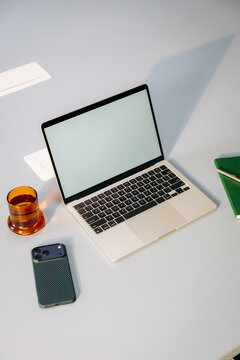 A laptop with a white screen on a desk