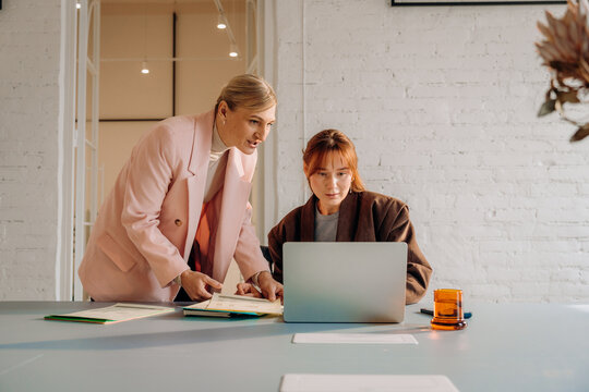 A woman uses a laptop in the office