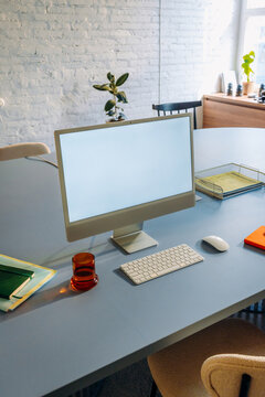 A computer monitor with a white screen on the table