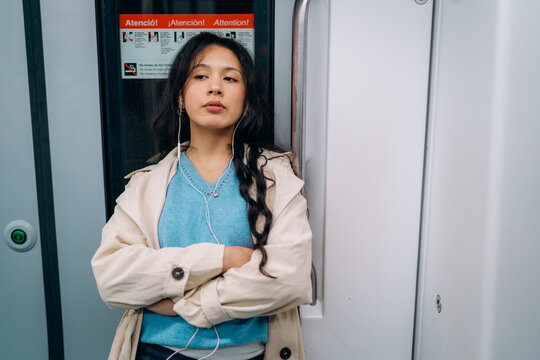 A woman standing in a subway car