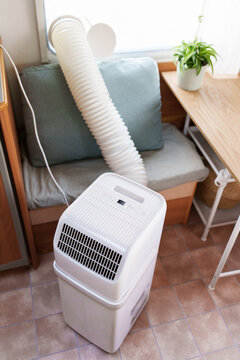 Portable air conditioner unit operating inside a modern camper van during a summer heatwave