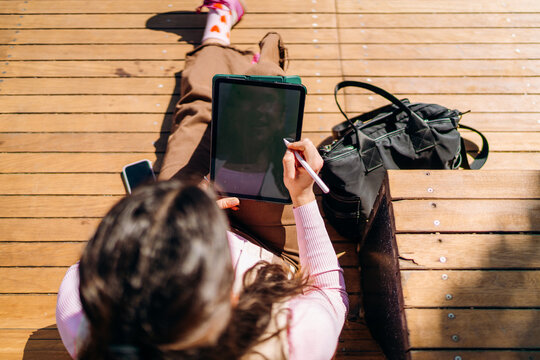 A woman using a tablet in the city