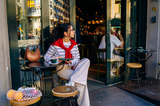 A woman using a tablet in the city