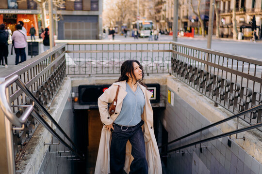 A woman getting off the subway