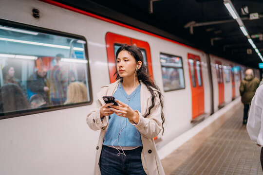 A woman using a mobile phone in the subway