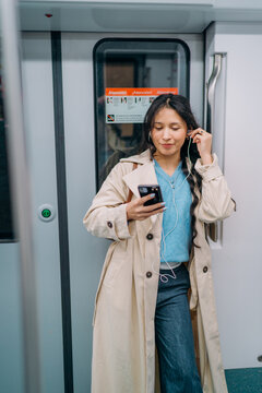 A woman standing in a subway car