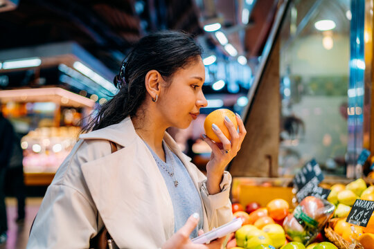 A woman buys fruits at the market