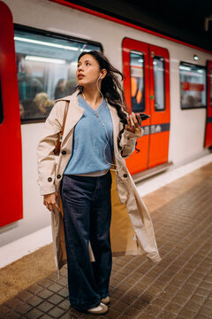 A woman using a mobile phone in the subway