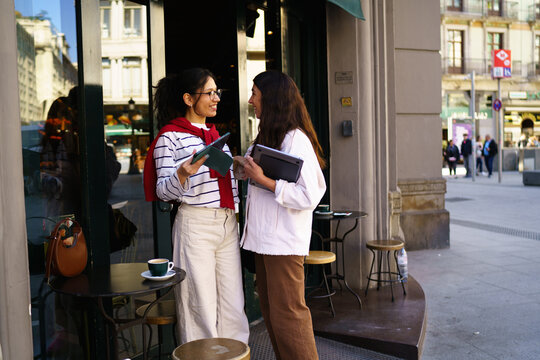 A women using a tablet and laptop in the city