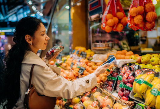 A woman pays for her purchases with a mobile phone