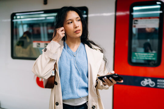 A woman using a mobile phone in the subway