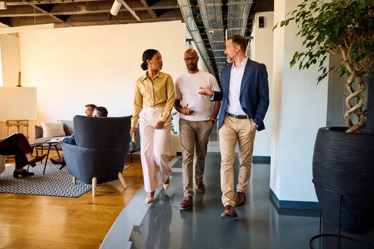 Colleagues walk through corporate environment