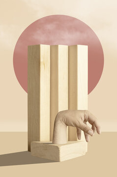 Hand standing on construction made from wooden blocks