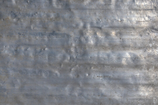Weathered aluminum surface texture in industrial outdoor setting