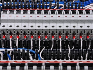Fototapeta premium Connecting electrical modules using copper insulated electrical wires in the electrical switchboard. 