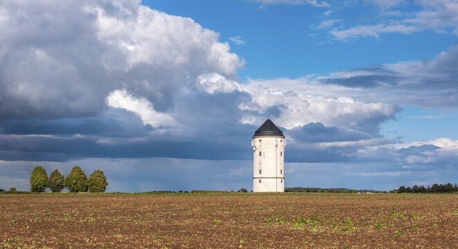 Water tower Cr&ouml;lpa-L&ouml;bsch&uuml;tz, field landscape with ploughed field under a stormy sky with dramatic clouds, near Naumburg, Saxony-Anhalt, Germany