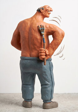 Humorous Clay Sculpture of a Man Using a Mechanical Back Scratcher
