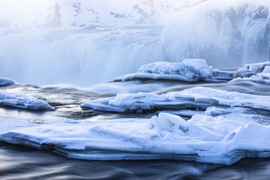 Icefall at the edge of the Godafoss waterfall at dawn, snow-covered landscape, Northern Iceland Eyestra, Iceland