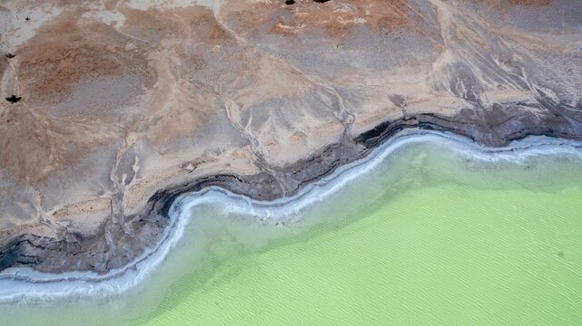 Aerial view of the salt lake in Kondinin with its vibrant turquoise water and white salt crust shoreline in the arid landscape of Kondinin, Western Australia, Australia.