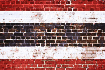 Distressed Brick Wall Painted with Horizontal Stripes in Red, White, and Black Colors, Showcasing a Vintage Textured Background © Mulkan