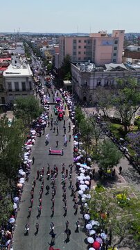 Aerial drone flight over a top down view of the dense city grid and streets on a sunny day, central Mexico.