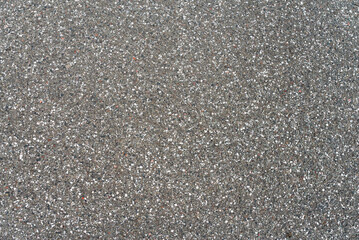 Close-up of dark asphalt road surface with aggregate texture © Kianoosh