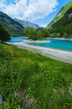 The view of Lake Tenno, a splendid alpine lake nestled between mountains and woods, near Lake Garda, near the town of Tenno, Trentino, Italy - May 2026