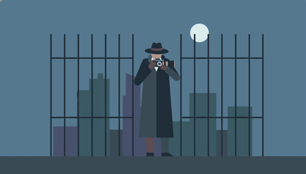Mystery detective in a trench coat and hat using a camera to photograph city buildings at night behind a dark metal fence silhouette.