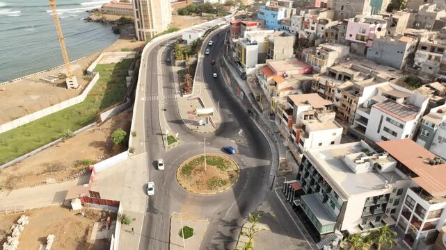 Praia, Cape Verde - coastal road, roundabout and colorful hillside houses, aerial drone view