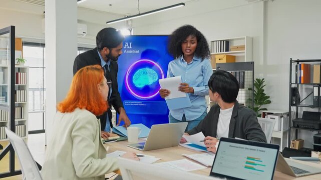 Diverse multiracial team planning new business strategy with AI marketing consultant on multiple screens and documents in modern open office, corporate restructuring and transformation concept