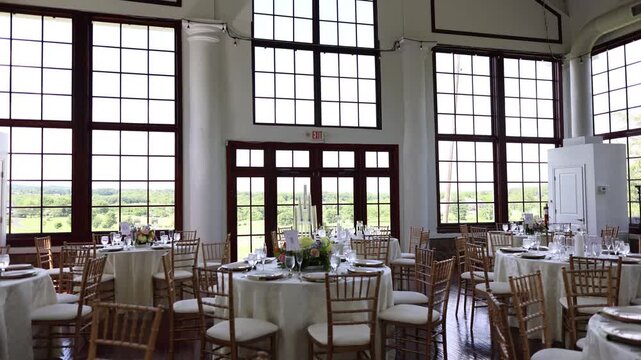 Bright wedding reception hall with large windows